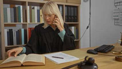 Woman talking on phone while reading book in judge office