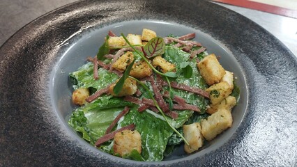 Fresh Caesar Salad Topped with Crunchy Croutons and Smoky Bacon