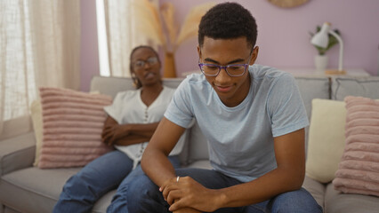 Obraz premium Mother and son spending time together in a cozy living room, capturing a moment of family bonding in an indoor setting with a modern interior