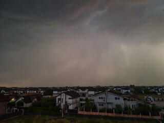 Rural settlement on the plain filmed from drone in cloudy summer weather. Beginning of a strong...