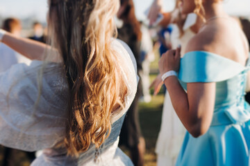 High school graduates dancing on prom, waltz and classical ball slow dance in dresses and suits on...