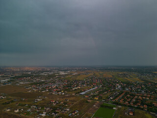 Rural settlement on the plain filmed from drone in cloudy summer weather. Beginning of a strong...