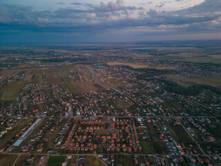 Rural settlement on the plain filmed from drone in cloudy summer weather. Beginning of a strong...