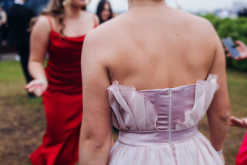 High school graduates dancing on prom, waltz and classical ball slow dance in dresses and suits on...