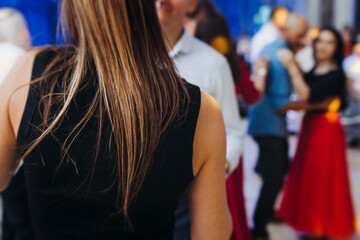 High school graduates dancing on prom, waltz and classical ball slow dance in dresses and suits on...