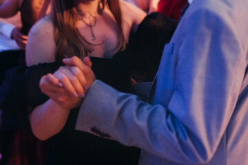 High school graduates dancing on prom, waltz and classical ball slow dance in dresses and suits on...
