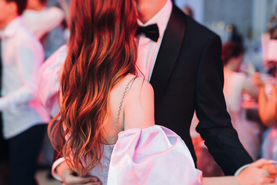 High school graduates dancing on prom, waltz and classical ball slow dance in dresses and suits on school graduation party, boys and girls ballroom dancers, couples dance quadrille and polonaise