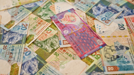 Fototapeta premium Hong kong dollar banknotes scattered on a flat surface showcasing colorful currency from hong kong in a close-up financial scene.