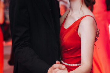High school graduates dancing on prom, waltz and classical ball slow dance in dresses and suits on...
