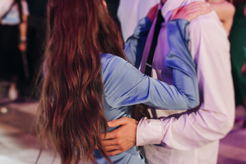 High school graduates dancing on prom, waltz and classical ball slow dance in dresses and suits on...