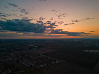 Residential neighborhood seen from above. Lots of houses in a field at sunset. Human settlements on the outskirts of the city 4k