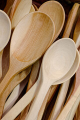 A variety of wooden spoons of various shapes and sizes, abstract hobby or houseware background.