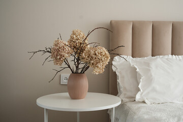 This is a beautifully styled Elegant Dried Floral Arrangement showcased in a Modern Bedroom