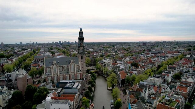 Stunning aerial footage of Westerkerk, the Protestant church in Amsterdam showcasing its iconic architecture, and vibrant cityscape.