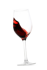 Red wine splashing in glass on white background