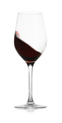 Red wine splashing in glass on white background