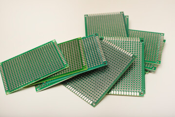 A green breadboard for electronics. The printed circuit board.