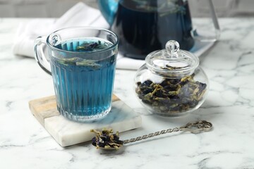Delicious butterfly pea flower tea on white marble table