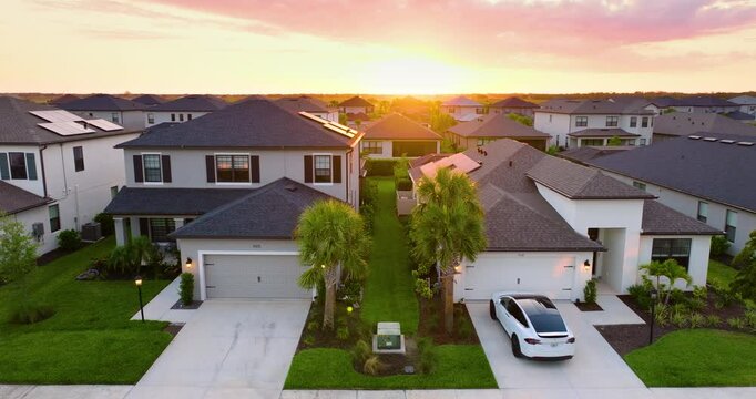 Gated community with expensive houses between green palm trees in southwest Florida. Premium housing development in the USA
