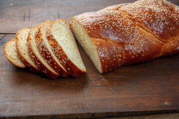 Easter sweet bread, homemade tsoureki braid on wooden table, closeup