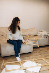 Woman Assembling Furniture on a Comfortable Couch in a Cozy Living Room