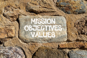 Mission objectives values symbol. Concept words Mission Objectives Values on beautiful grey stone...