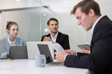 Colleagues collaborating on a project in a modern office