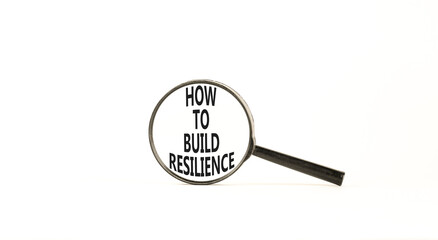 How to build resilience symbol. Concept words How to build resilience on beautiful magnifying glass. Beautiful white table white background. Business and how to build resilience concept. Copy space.