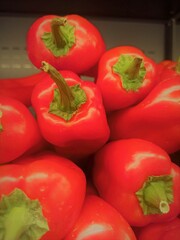 Bright red peppers against each other.