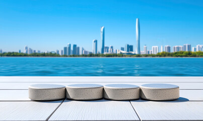 Obraz premium Tranquil Waterfront Scene with Round Stones on Dock, Modern City Skyline in Background Under Clear Blue Sky, Perfect for Serenity and Nature Themes