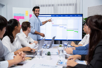 Project manager communicate and collaborate with team using project management software display on...