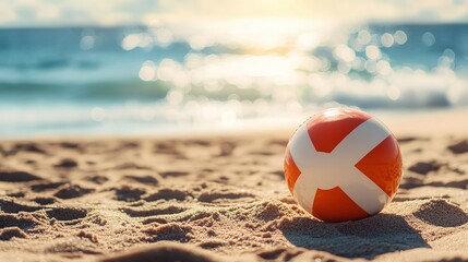 Obraz premium Beach Ball Resting On Sandy Shore Near Ocean