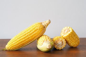 Fresh corn on wooden table background
