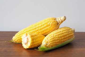 Fresh corn on wooden table background