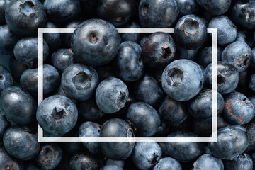 Blueberry background. Texture of fresh blueberries close-up. Sprinkle blueberries. Ripe blueberries with copy space. Scattered fresh blueberries