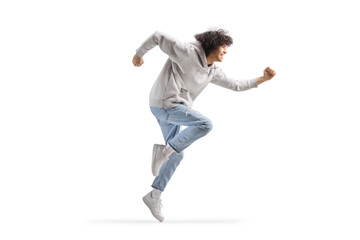 Full length profile shot of a young man making a funny dance