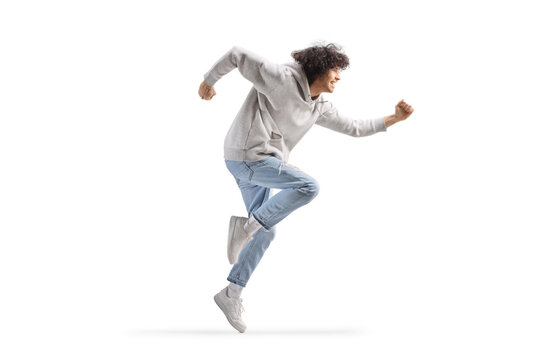Full length profile shot of a young man making a funny dance