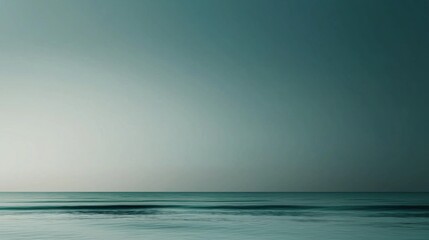 A tranquil ocean stretches out under a soft twilight sky, the calm waters reflecting gentle hues. The horizon blends seamlessly with the peaceful atmosphere, creating a serene view