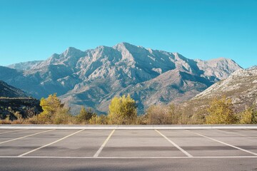 A parking lot scene with mountains in the background