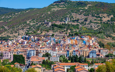 Fototapeta premium aerial view of an old village with pastel colored houses on the hills of Sardinia