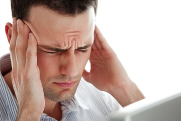 Fototapeta premium A person feeling frustrated or overwhelmed while working on their laptop