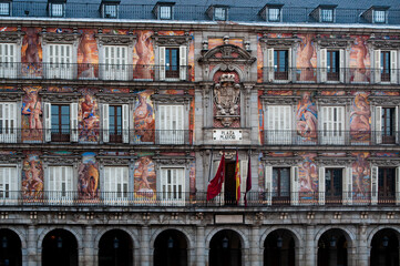 Detail of the colorful frescoes painted on the side of a building overlooking the Plaza Mayor or...