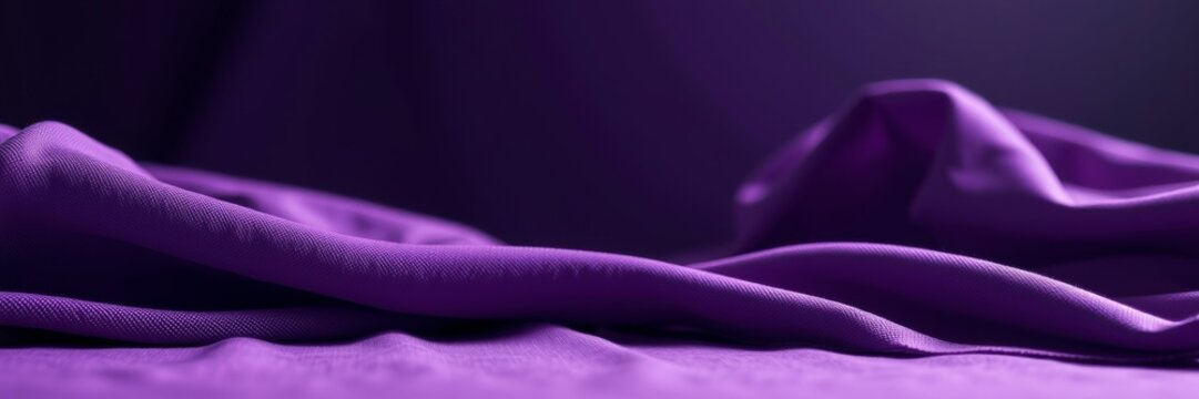Purple fabric flowing with a serene mood representing elegance against a soft background
