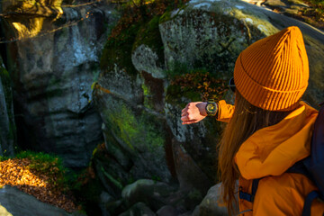 Over the shoulder view of Female Checking Current Altitudeon Casio Wrist Watch While Exploring a...