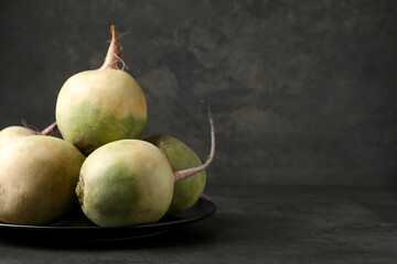Whole fresh ripe turnips on grey table, closeup. Space for text