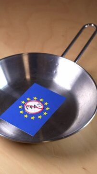 Pfas ban in european union represented by a small flag in a frying pan