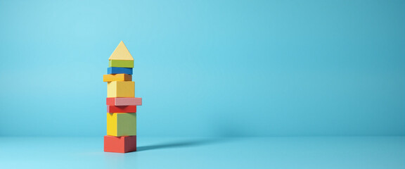 Fototapeta premium Colorful building blocks stacked creatively against a vibrant blue background, conveying playfulness and imagination, representing the spirit of creativity and childhood exploration