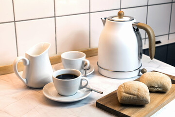 Breakfast served on the kitchen table with fresh bread and coffee