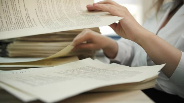 Office Worker Organizing Paper Documents