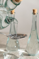 White distilled vinegar is poured into spoon